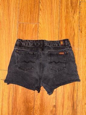 Black denim shorts with a distressed look